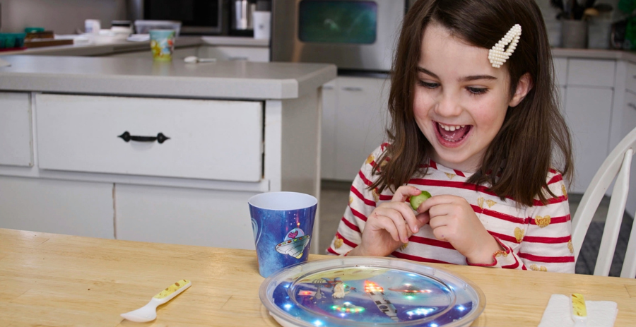 Girl with YumLit light-up plate.